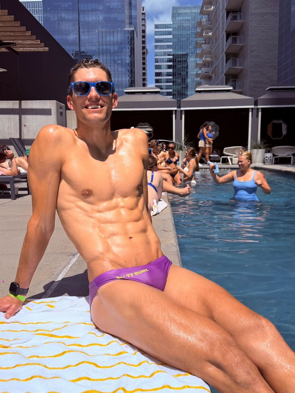 Salty Bunz Bikini Swim Brief Ultra-Thin 3.5cm Saffron Seas Purple with white background Pool front Gay swimwear Model Cooper