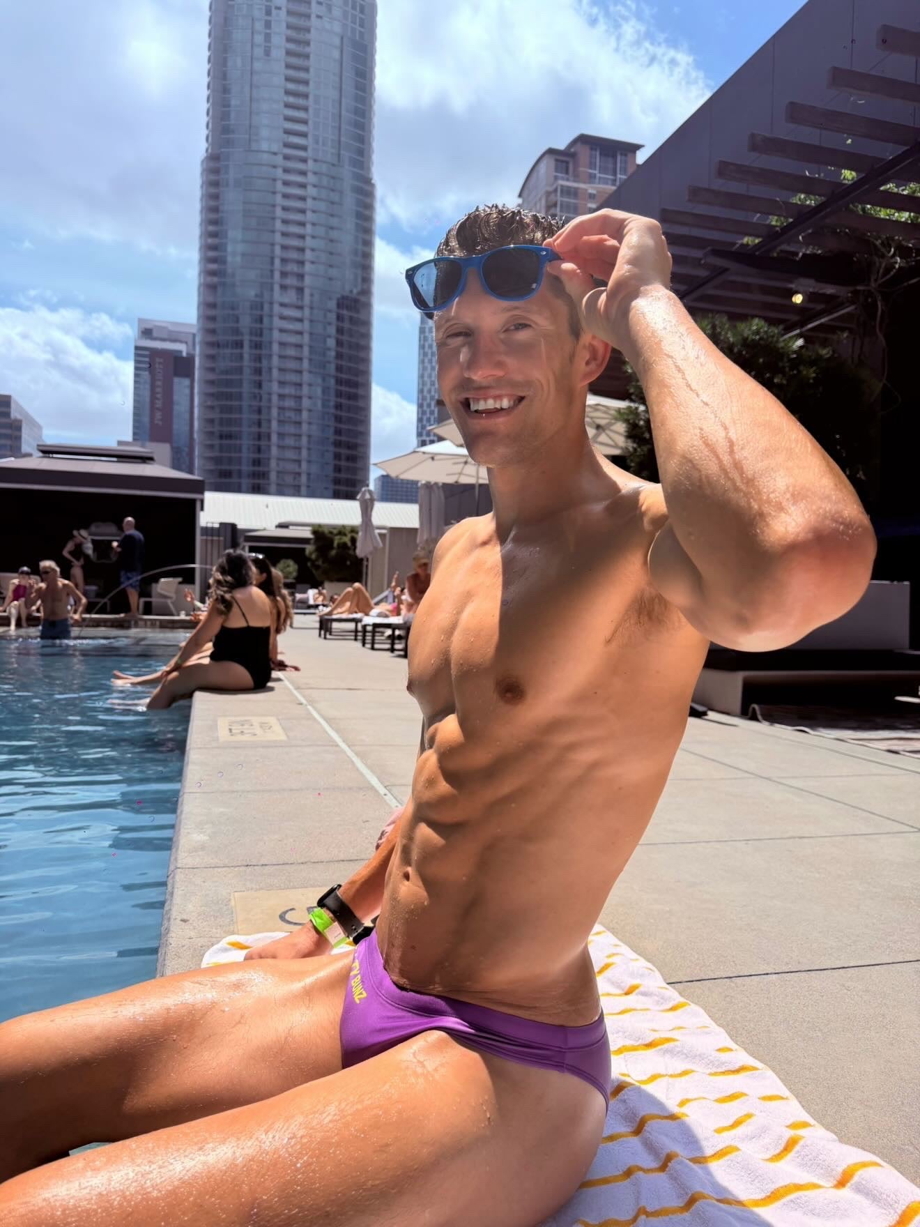 Salty Bunz Bikini Swim Brief Ultra-Thin 3.5cm Saffron Seas Purple with white background Pool side front Gay swimwear Model Cooper
